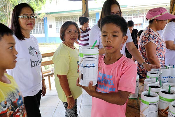An SOS child holding a pot containing kangkong seedlings during an urban farming workshop in SOS Children’s Village Lipa on November 22, 2019.